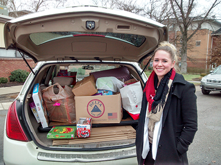 Kelsey Moss with a trunk full of toys  